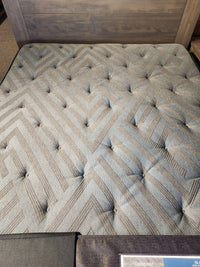 A close-up of the Beauty-rest Isla PT Firm Mattress with pocket coils and geometric, tufted button details.
