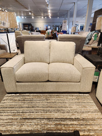 The Leather Craft Mesa Loveseat with square arms adds modern elegance and comfort to any furniture showroom.