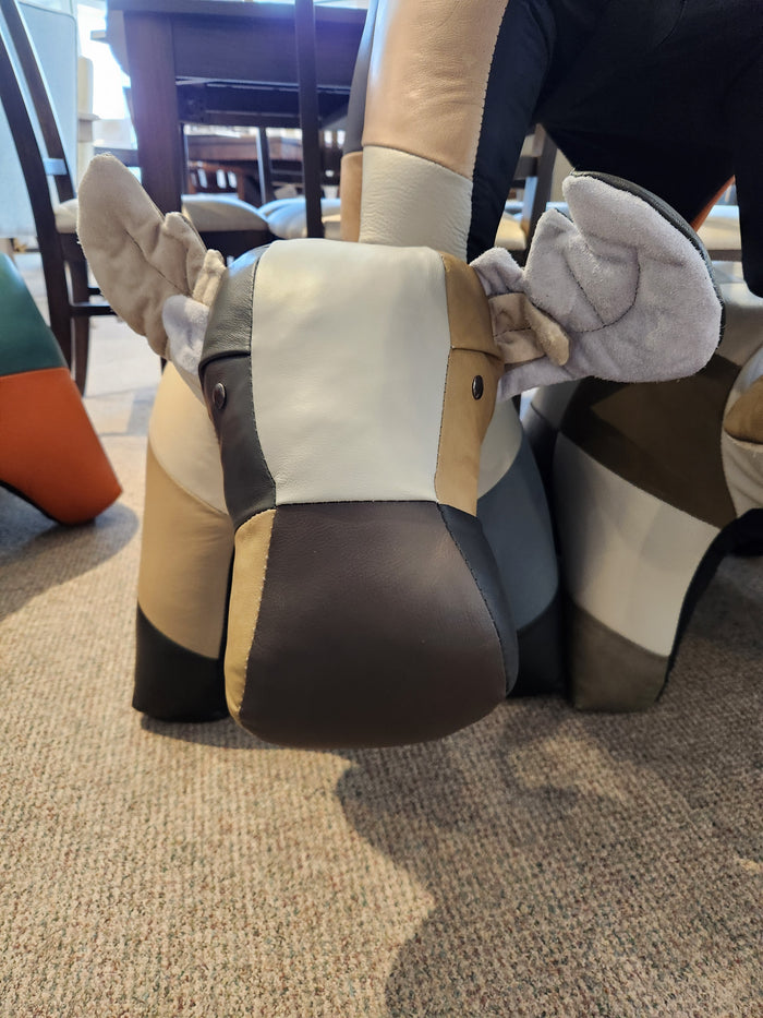 Reiner's Originals Reiner's Leather Animal Ottomans--Moose, in various colors, sits on a carpeted floor.