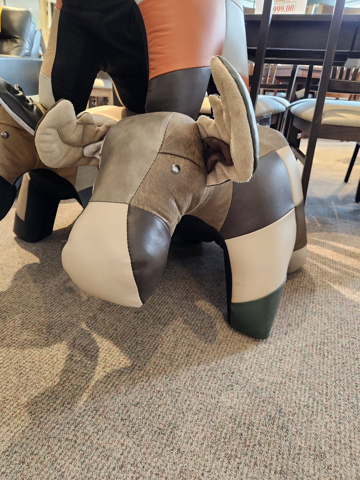 Reiner's Originals Reiner's Leather Animal Ottomans--Moose, a faux leather moose ottoman on a carpeted floor.