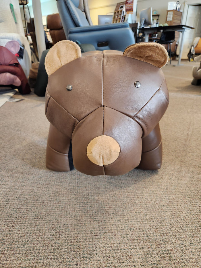 Reiner's Originals Reiner's Leather Animal Ottomans-- Bear on display atop carpet in a furniture store showroom.