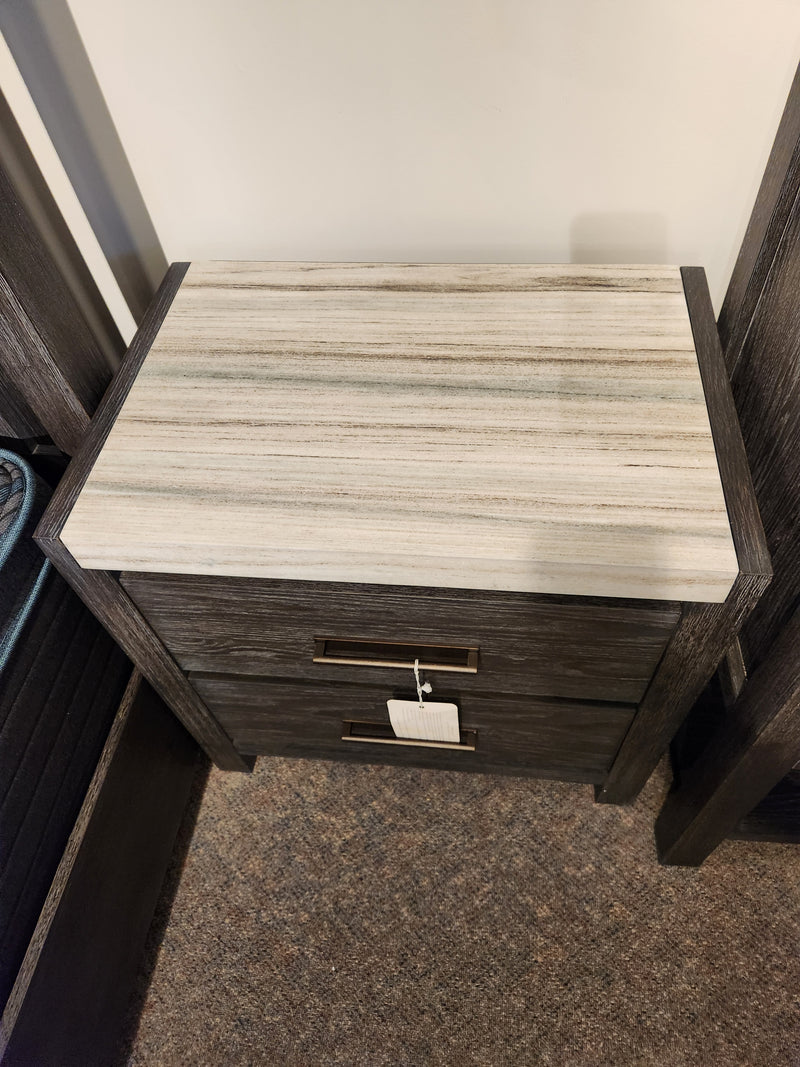 The Magnussen B5990 Plum Creek Night Stand features 2 drawers, a light top, black sides, and bronze hardware.