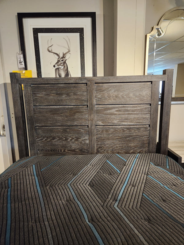 The Magnussen Plum Creek B5990 Queen Storage Bed with burnished bronze hardware, geometric comforter, and deer photo.