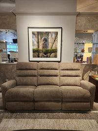 The La-z-boy 786 Liam Power Reclining Sofa in beige sits below a framed owl photo in a stylish, decorated showroom.