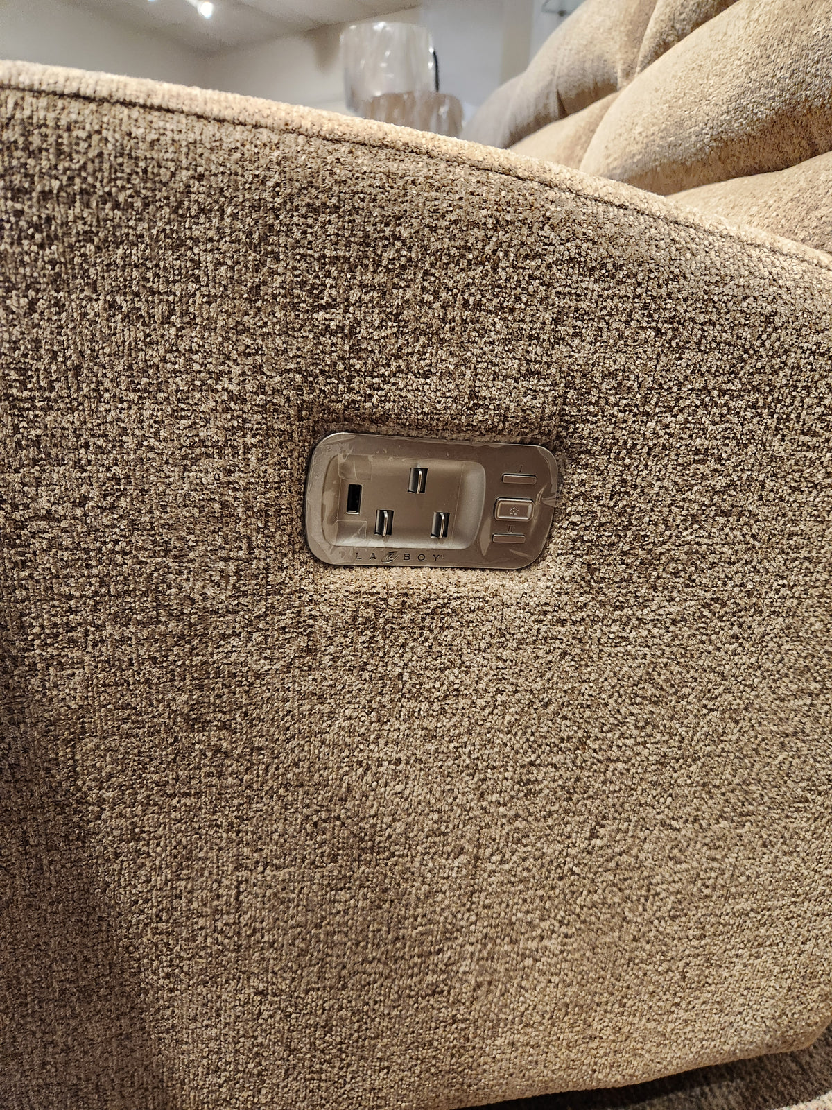 Close-up of La-z-boy 786 Liam Power Reclining Sofa with built-in panel featuring power sockets and USB ports.
