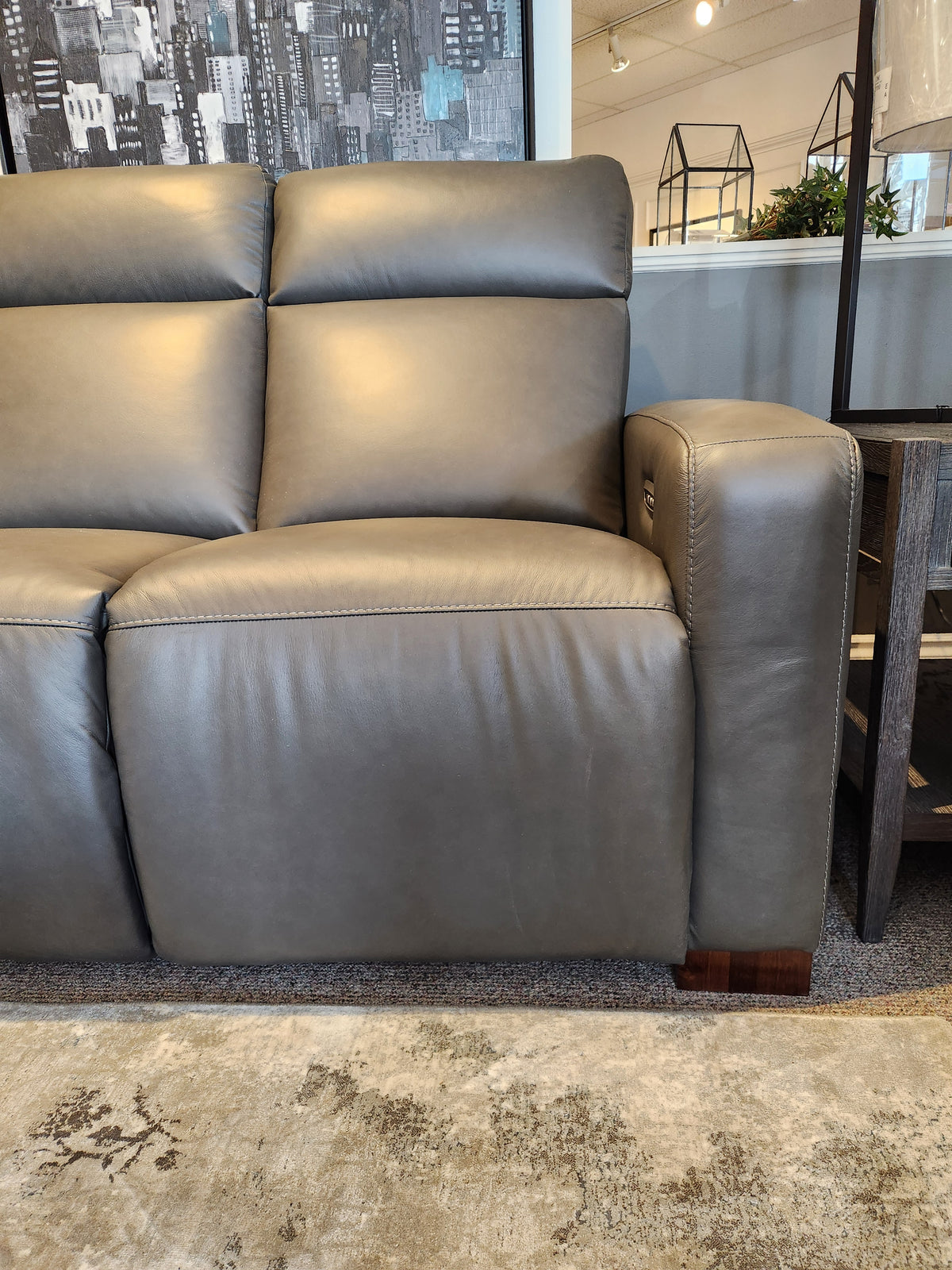 La-z-boy 811 Acadia Power Reclining Sofa w/ Headrest & Zero Grav, shown beside a rug, side table, and indoor plants.