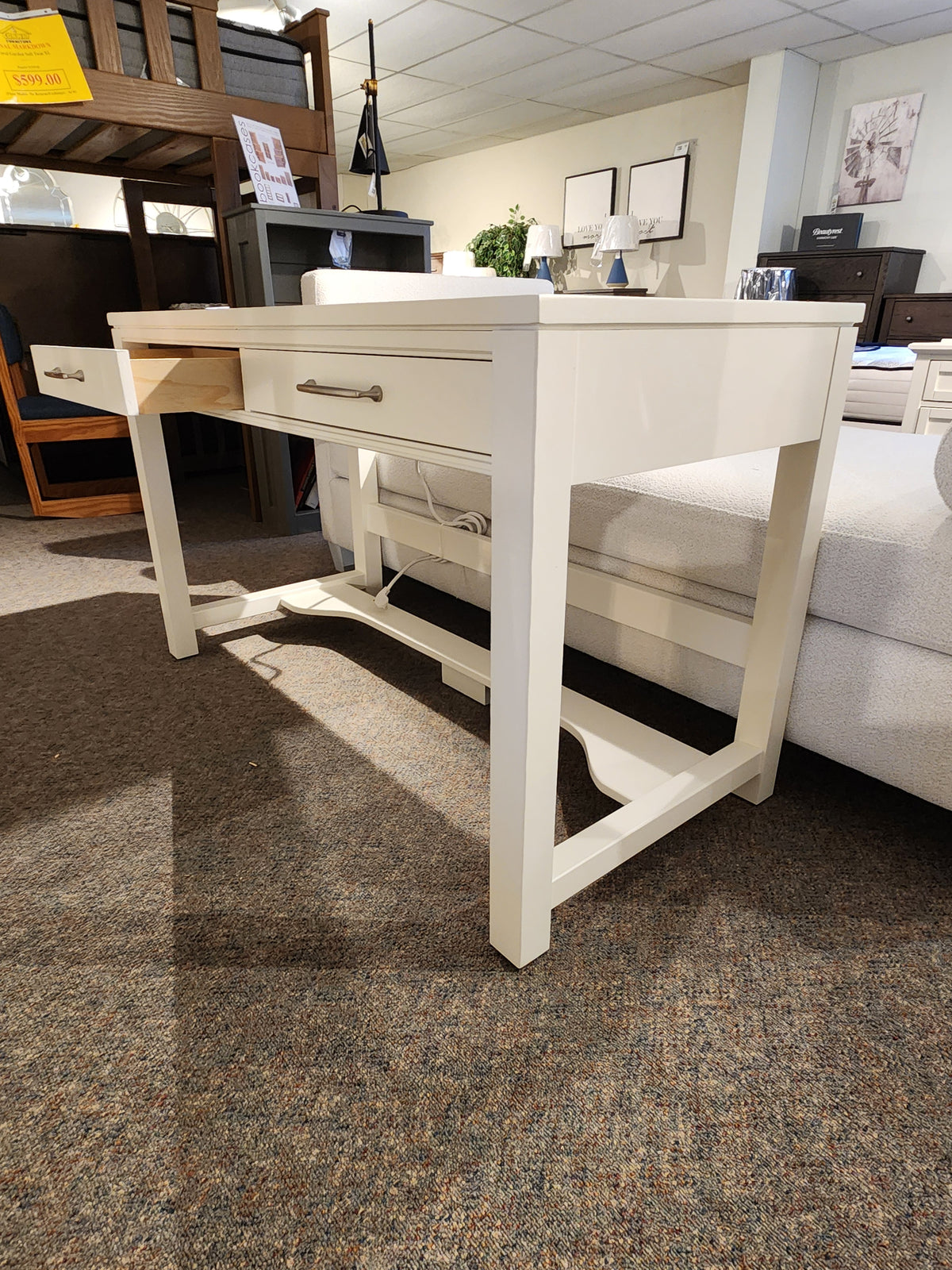 834 Laptop Desk by Ben & Erin Napier for Vaughan Bassett, white wood with storage, shown on brown carpet.