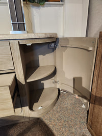 The Magnussen D5874 Braelyn Buffet w/Stone Top features two curved shelves and an open door revealing storage inside.
