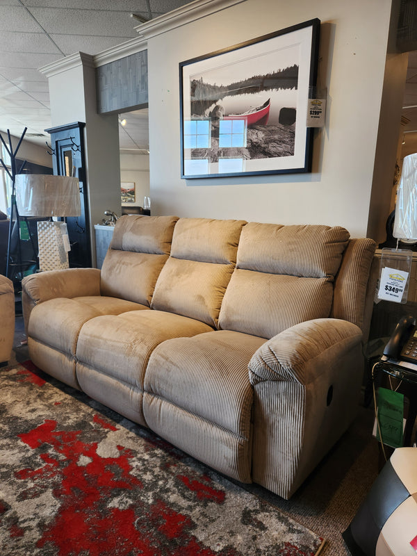 La-z-boy 761 Joel Reclining Sofa in tan corduroy with cushioned arm pads on a red and gray rug under canoe lake photo.