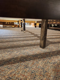 Low angle view under a Fashion Willa Queen Platform Bedframe with metal legs, highlighting its minimalist look on carpet.
