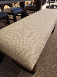 Magnussen D5878 Trestle 5 Piece Dining set includes a beige upholstered bench with textured fabric and Honey Wheat legs.