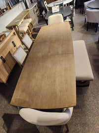 Magnussen D5878 Trestle 5 Piece Dining Package with four chairs and a bench in Honey Wheat finish on display.