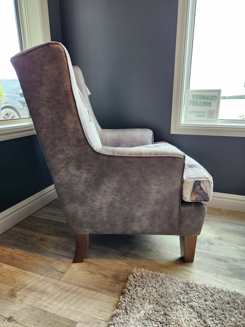 The Best Field & Stream Andrea FS2 Wing Back Chair features wooden legs and lodge-style comfort by the large windows.