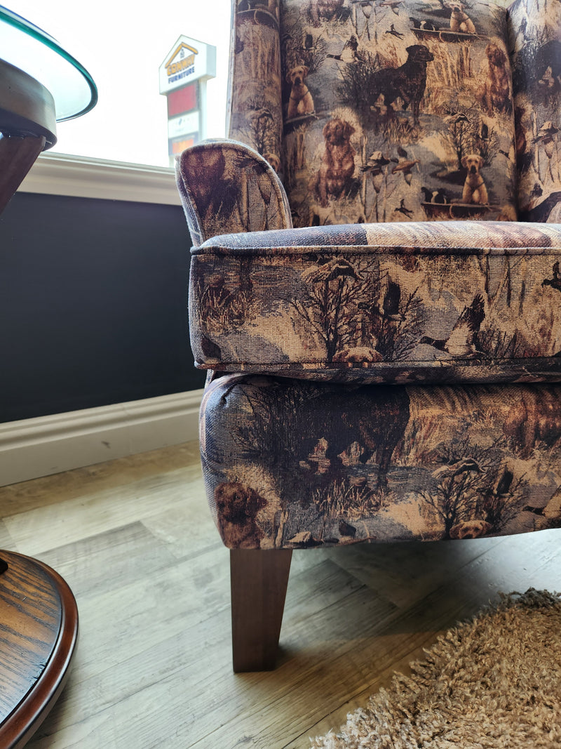 The Field & Stream Andrea Wing Back Chair by Best adds modern lodge-style charm with a dog print by the window.
