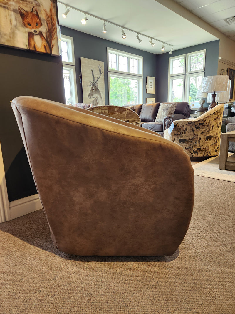 The Best Field & Stream Airily Swivel Chair sits in a showroom with large windows, wall art, and modern lodge décor.