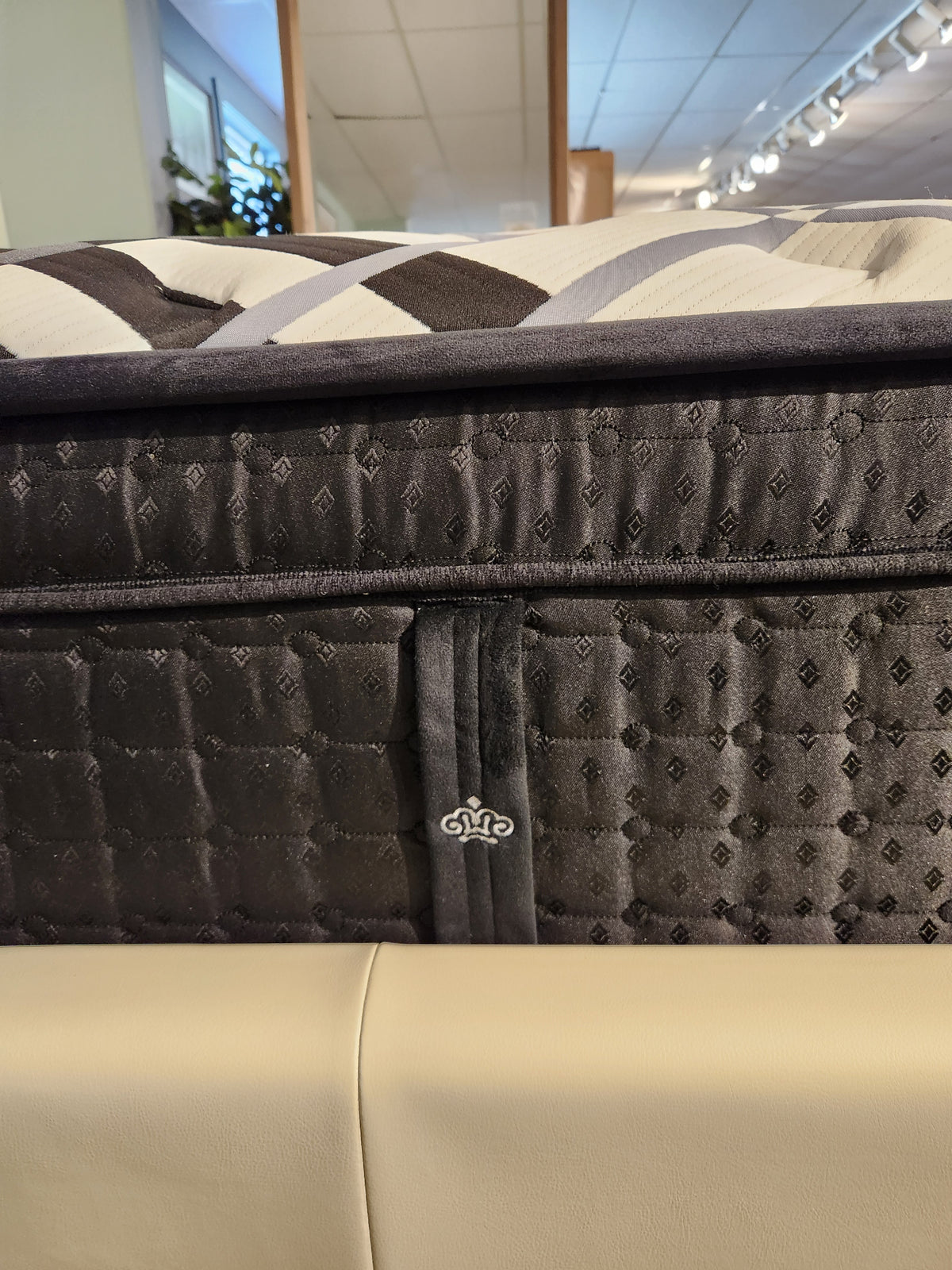 Close-up of the KingsDown Vermillion ET Plush Mattress with patterned stitching for pressure relief on display.