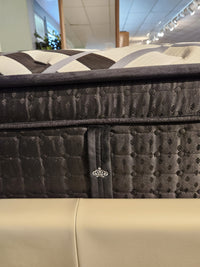 Close-up of the KingsDown Vermillion ET Plush Mattress with patterned stitching for pressure relief on display.