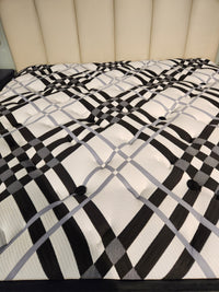 KingsDown Vermillion ET Plush Mattress with black and white plaid pattern, plus beige upholstered headboard for pressure relief.