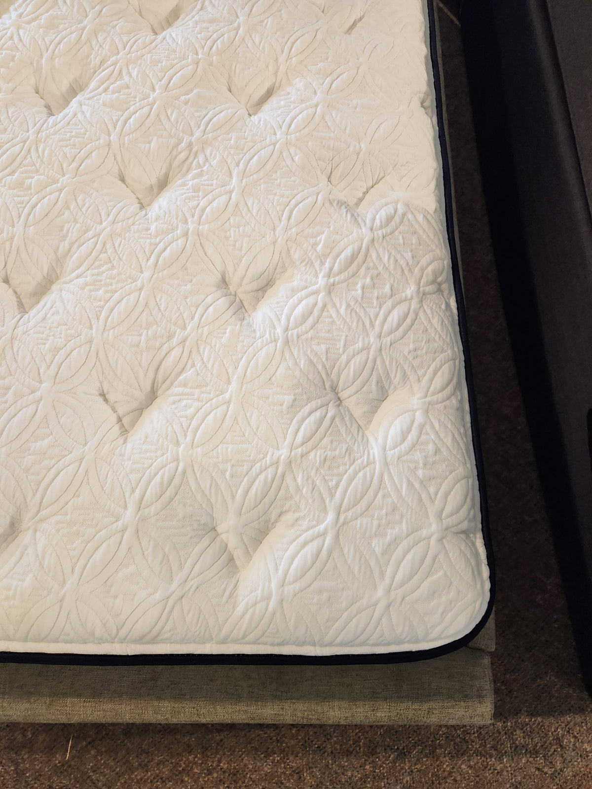 Close-up of the KingsDown Garland ET Plush Mattress featuring a textured, quilted cover for cool comfort.