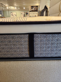 Close-up of a KingsDown Radiance 2 ET Plush Mattress with patterned sides, designed for pressure relief in a showroom.
