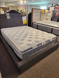 The KingsDown Paris 2 ET Plush Mattress, set on a grey bed frame in the showroom, offers superior comfort.
