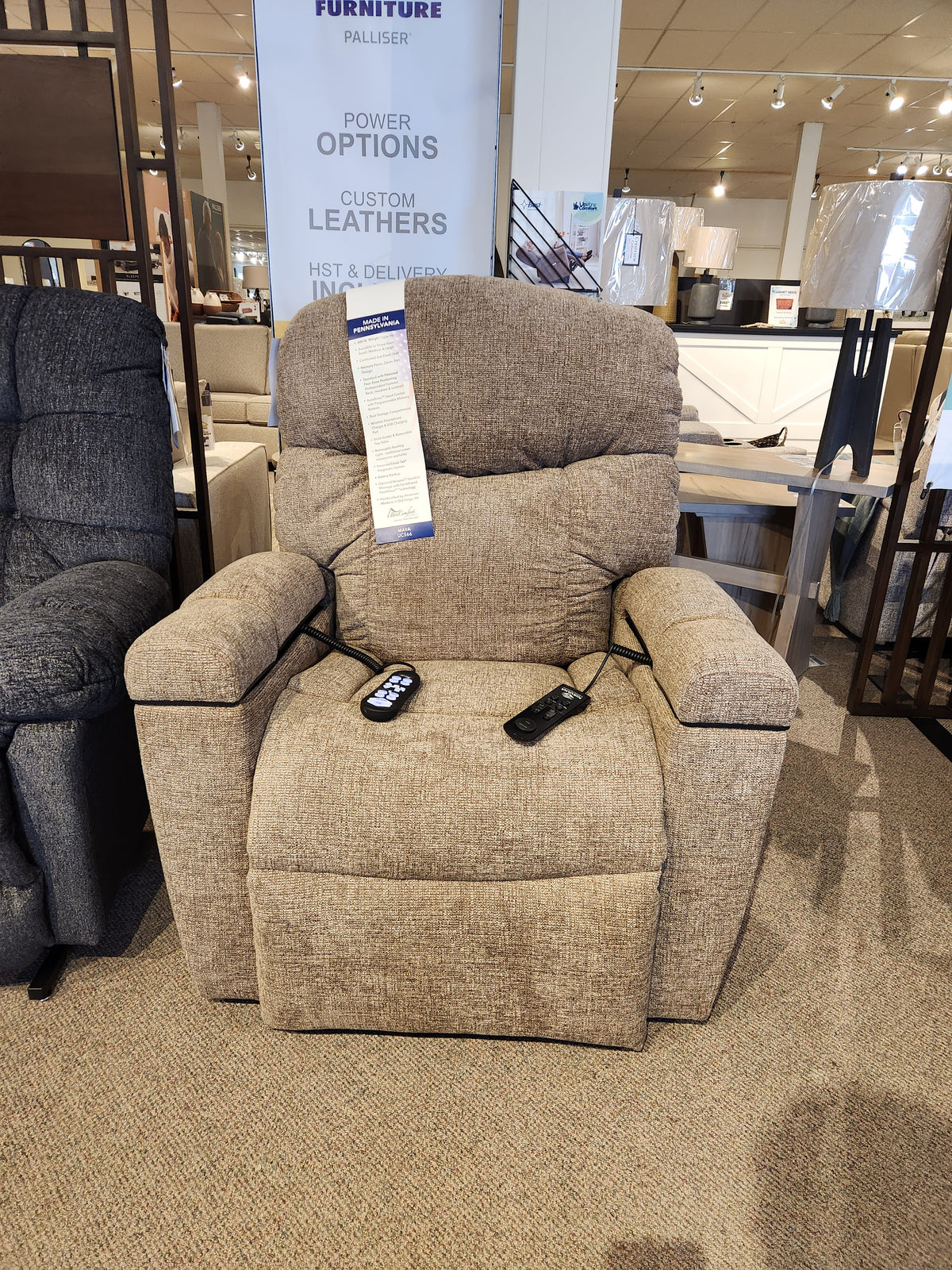 Golden Noah UC-566 Med Power Lift Chair in brown with two remotes and HeatWave tech, shown in a showroom.