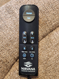 A Golden Noah UC-566 Med Power Lift Chair remote rests on brown fabric, showing massage and HeatWave settings.