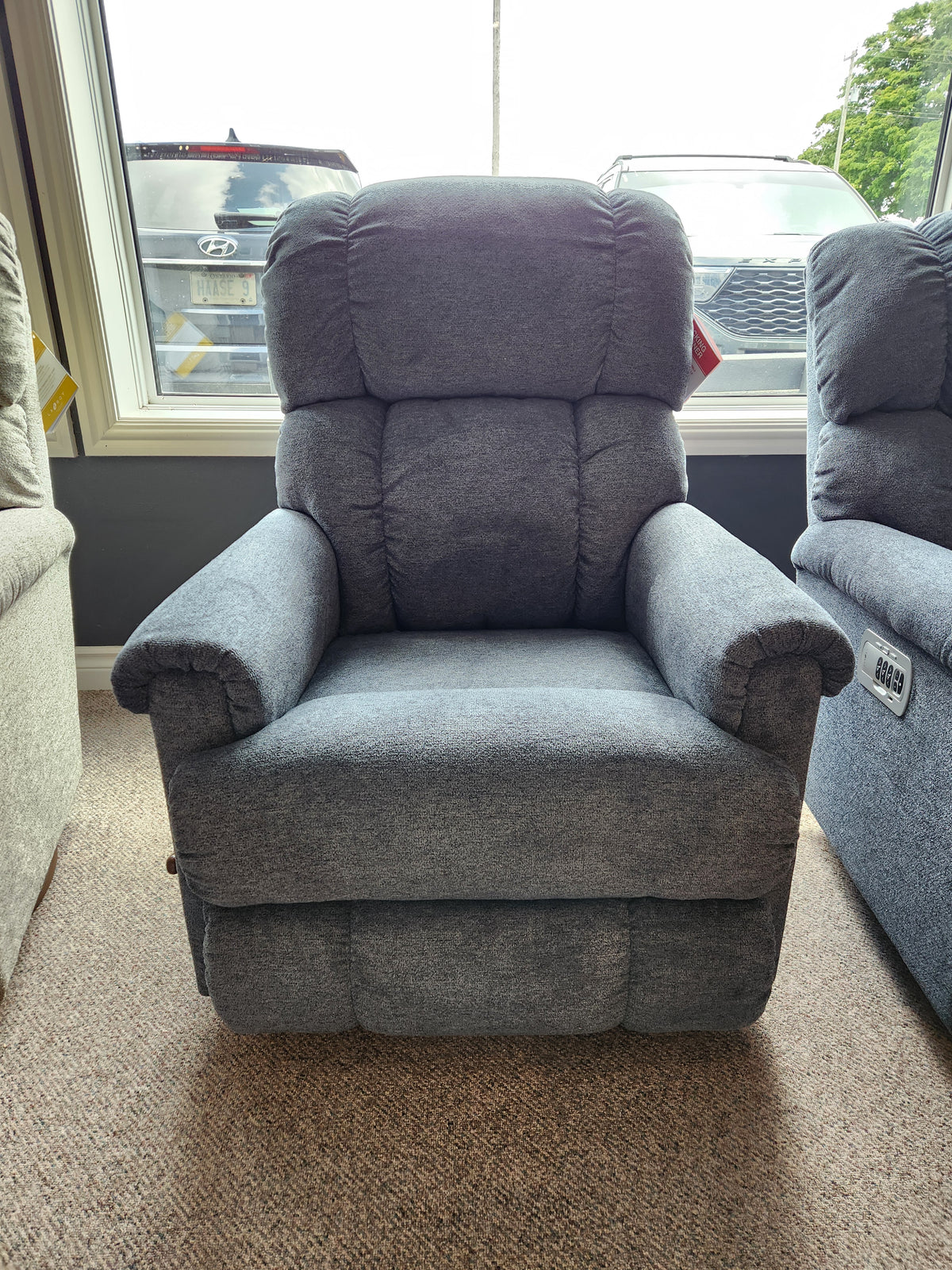 The La-z-boy 512 Pinnacle Rocker Recliner With Contour Cushion is shown indoors by a window with cars outside.