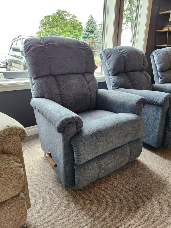 A La-z-boy 512 Pinnacle Rocker Recliner with contour cushion and wood lever is by the window in the showroom.