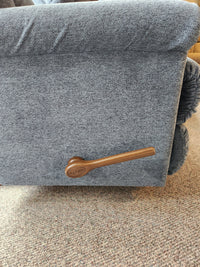 Close-up of the brown La-Z-Boy handle on the 512 Pinnacle Rocker Recliner With Contour Cushion, gray fabric, on carpet.