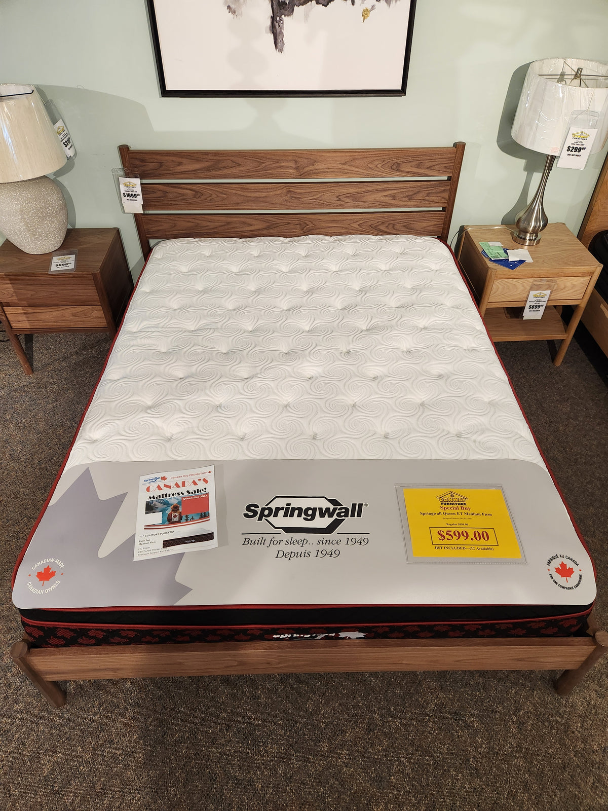 Springwall Canada Day Mattress by Springwall with Comfort Pockets HD foam on display—$599.00, promo signs on top.