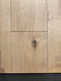 Close-up of Beckham Brothers' Montana Plank White Oak flooring, highlighting its grain patterns and central knothole.