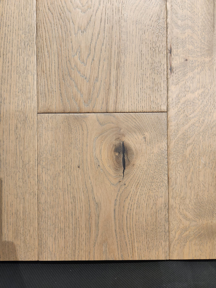 Close-up of Beckham Brothers' Montana Plank White Oak flooring, highlighting its grain patterns and central knothole.