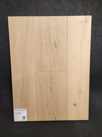 Sample board of Montana Plank White Oak hardwood by Beckham Brothers shows natural grain and small knots.