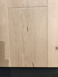 Montana Plank White Oak by Beckham Brothers: light premium hardwood with visible grain and dark streaks on black.