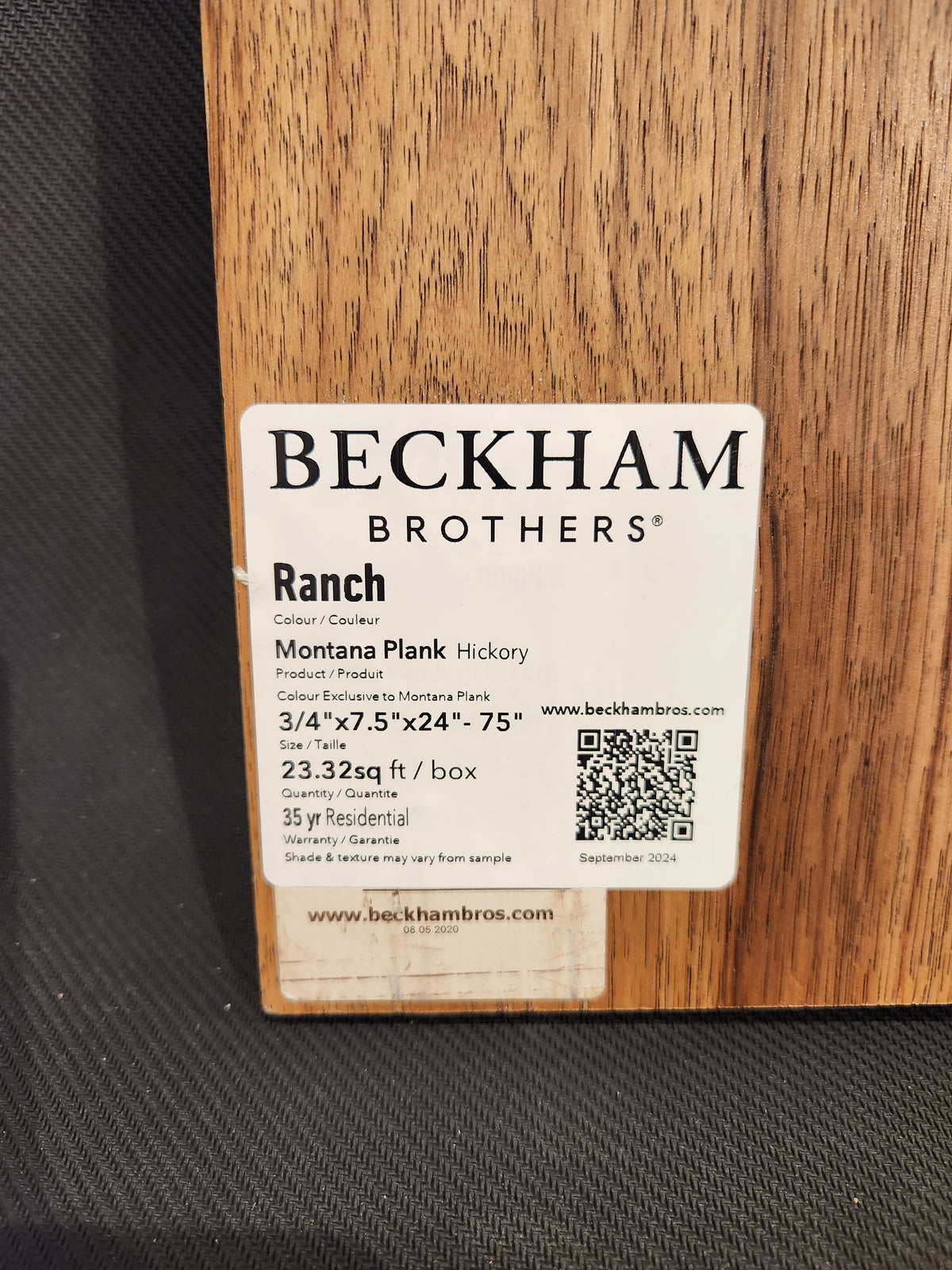 Label on wood plank sample detailing Beckham Brothers premium hardwood flooring, Montana Plank White Oak, size, and specs.