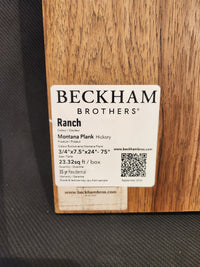Label on wood plank sample detailing Beckham Brothers premium hardwood flooring, Montana Plank White Oak, size, and specs.