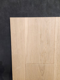 Montana Plank White Oak by Beckham Brothers displays its grain and pattern on a dark textured background.