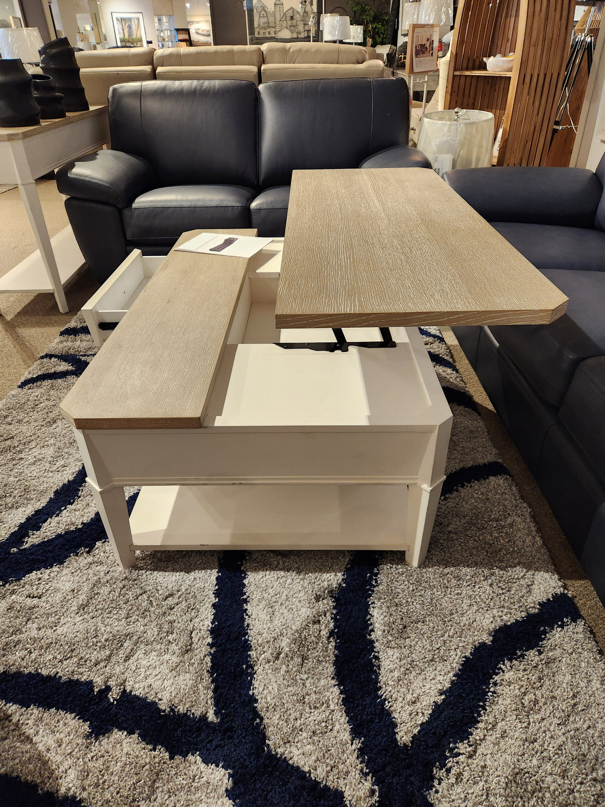 The Magnussen T6310-Echo Isles lift-top cocktail table sits open on a gray rug, showcasing transitional casual style.
