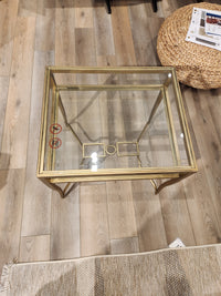 The Lorena End Table (T6300) by Magnussen features a square glass top and burnished brass, perfect for any inviting space.
