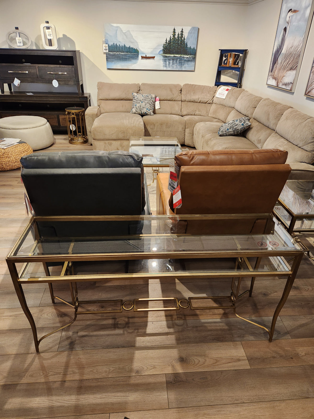 The Magnussen T6300 - Lorena Sofa Table adds classic style behind two armchairs in the showroom.