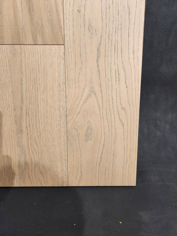 Three Beckham Brothers Heritage Plank White Oak panels with visible grain rest on a dark, textured surface.