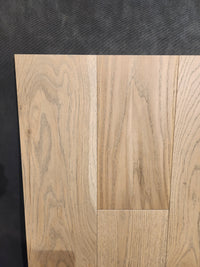 Three Heritage Plank White Oak panels by Beckham Brothers display unique grain, perfect for premium hardwood flooring.