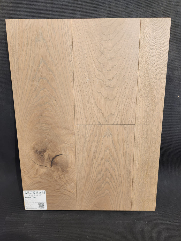 Sample board of Beckham Brothers New York Loft White Oak-Hardwood, light brown with visible grain and bottom left label.