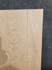 Two New York Loft White Oak-Hardwood panels by Beckham Brothers with visible grain on a dark, textured surface.