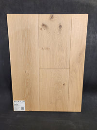 Sample board of New York Loft White Oak-Hardwood by Beckham Brothers, visible grain, labeled in bottom left corner.
