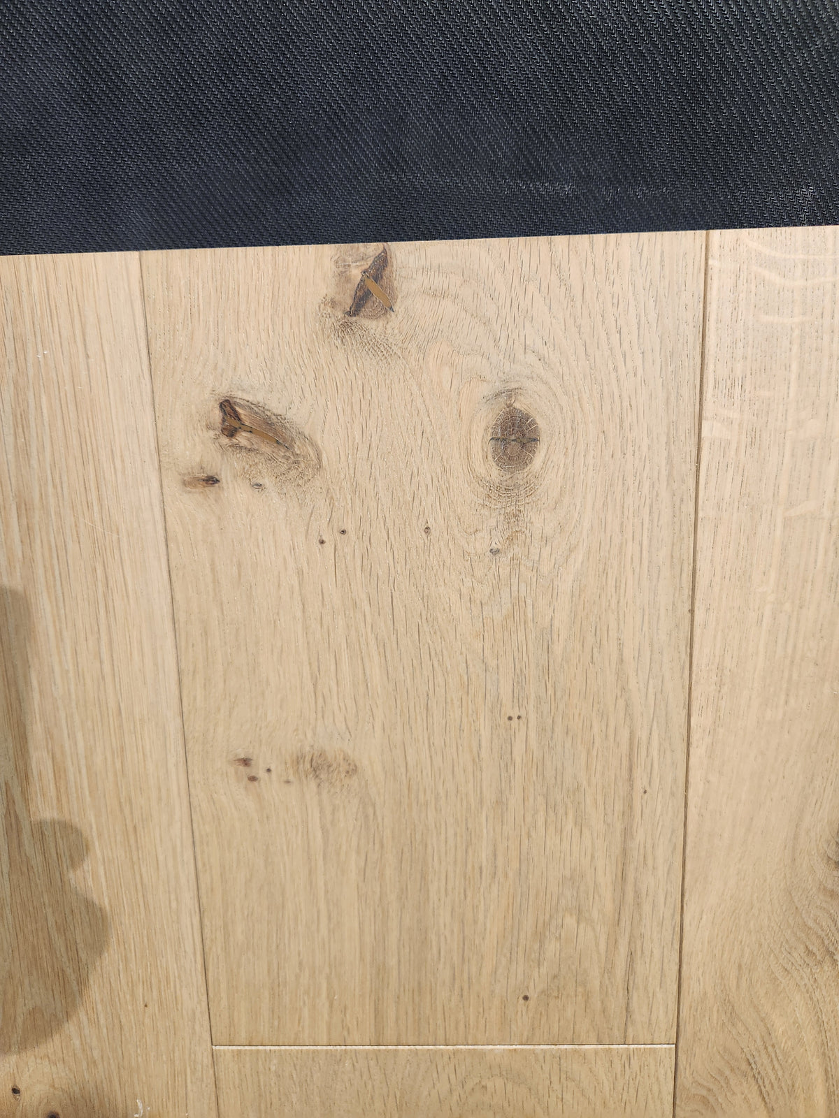 New York Loft White Oak-Hardwood by Beckham Brothers features light wood with knots and a dark textured border on top.