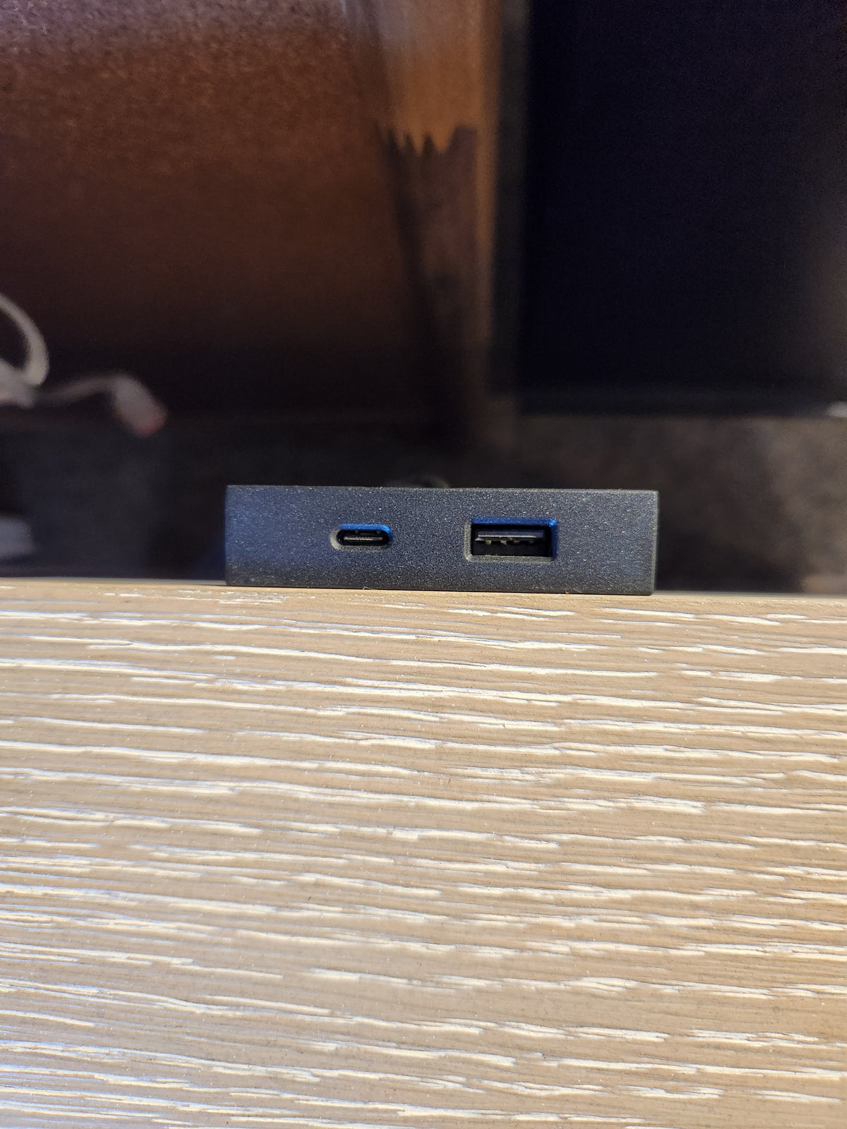 Close-up of USB-C and USB-A ports on the Magnussen B6310-Echo Isles Night Stand’s quartered oak surface.