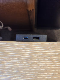 Close-up of USB-C and USB-A ports on the Magnussen B6310-Echo Isles Night Stand’s quartered oak surface.