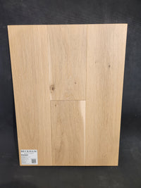 Light oak sample of Beckham Brothers Heritage Plank White Oak, three planks upright against a dark background.